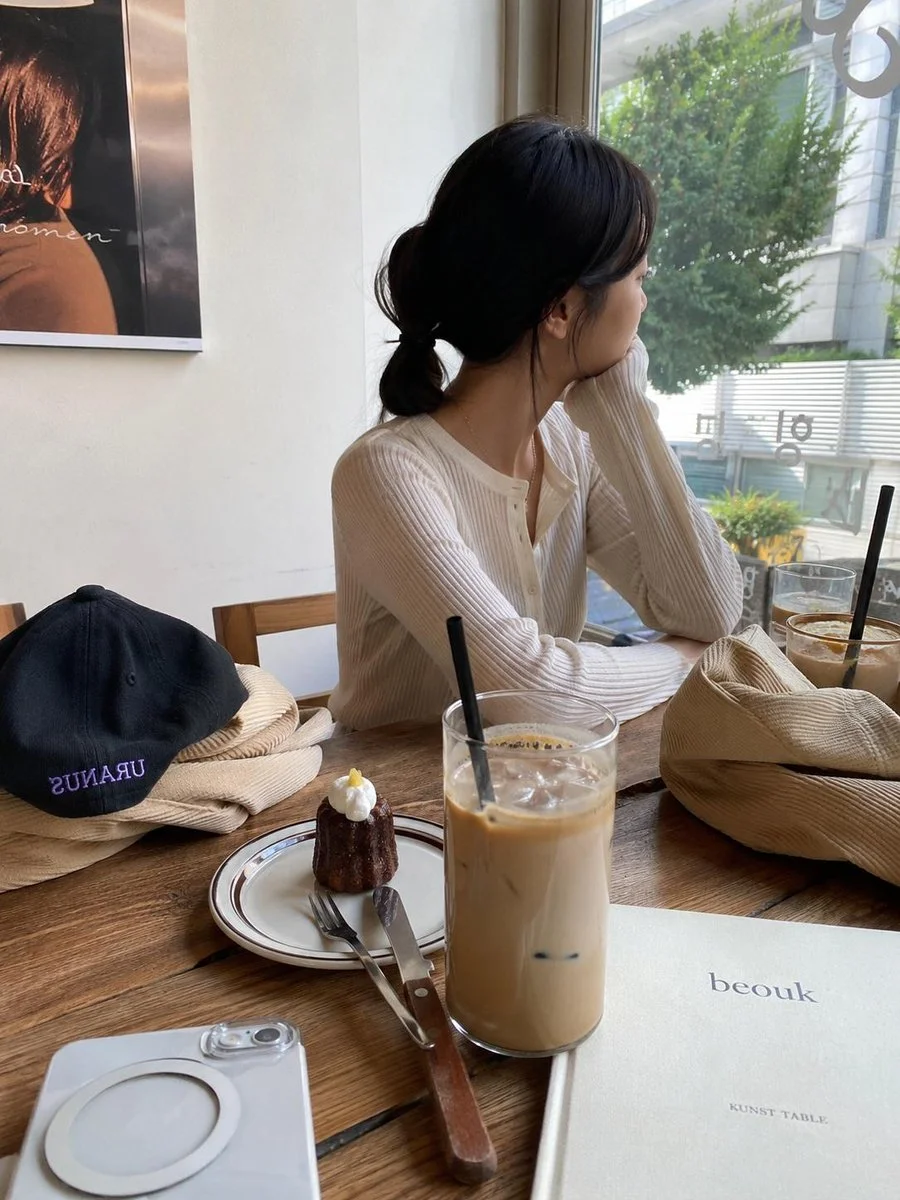 A cute Korean character enjoys a quiet coffee moment