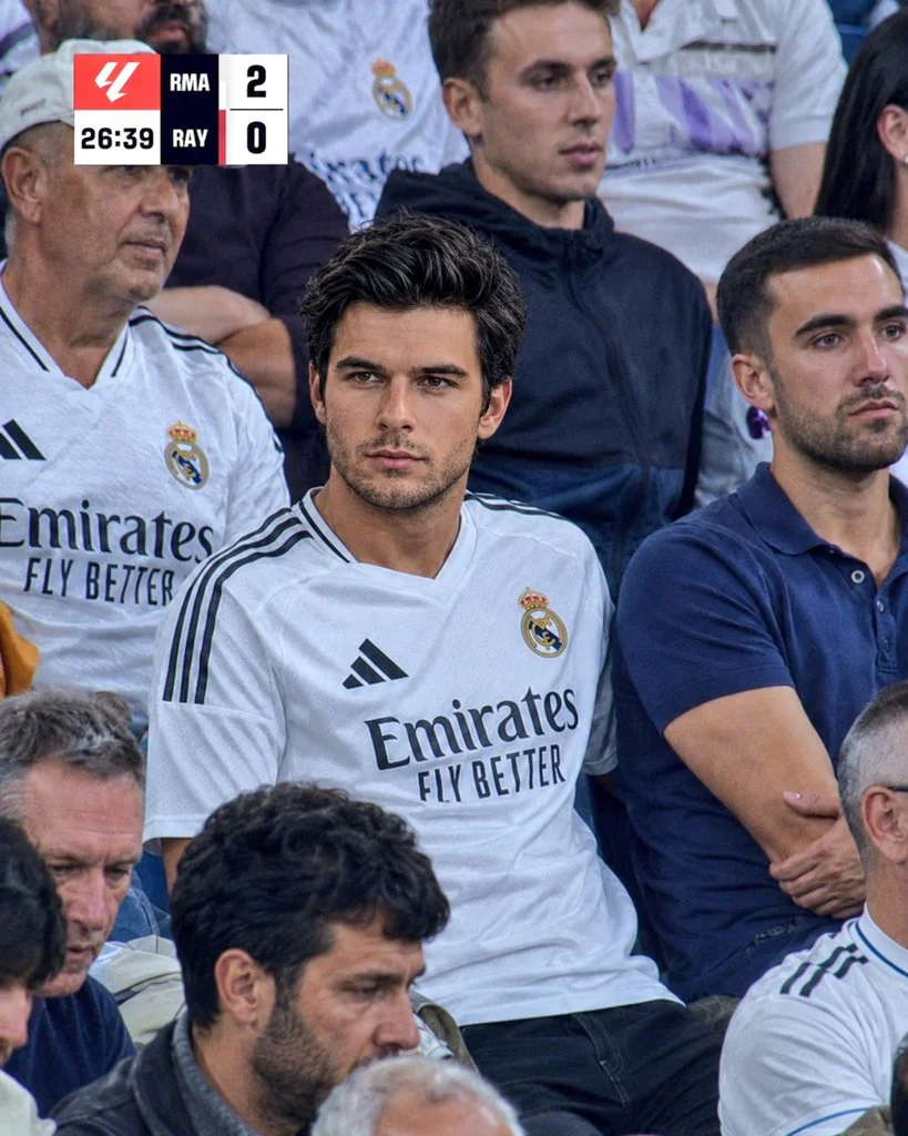 A devoted Real Madrid fan watches intensely from the packed stands.