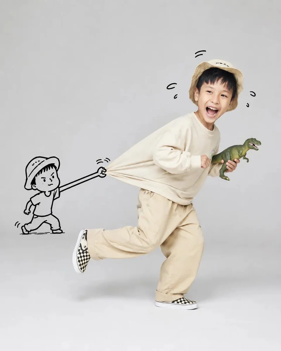 A joyful child runs while a cartoon figure pulls their shirt.