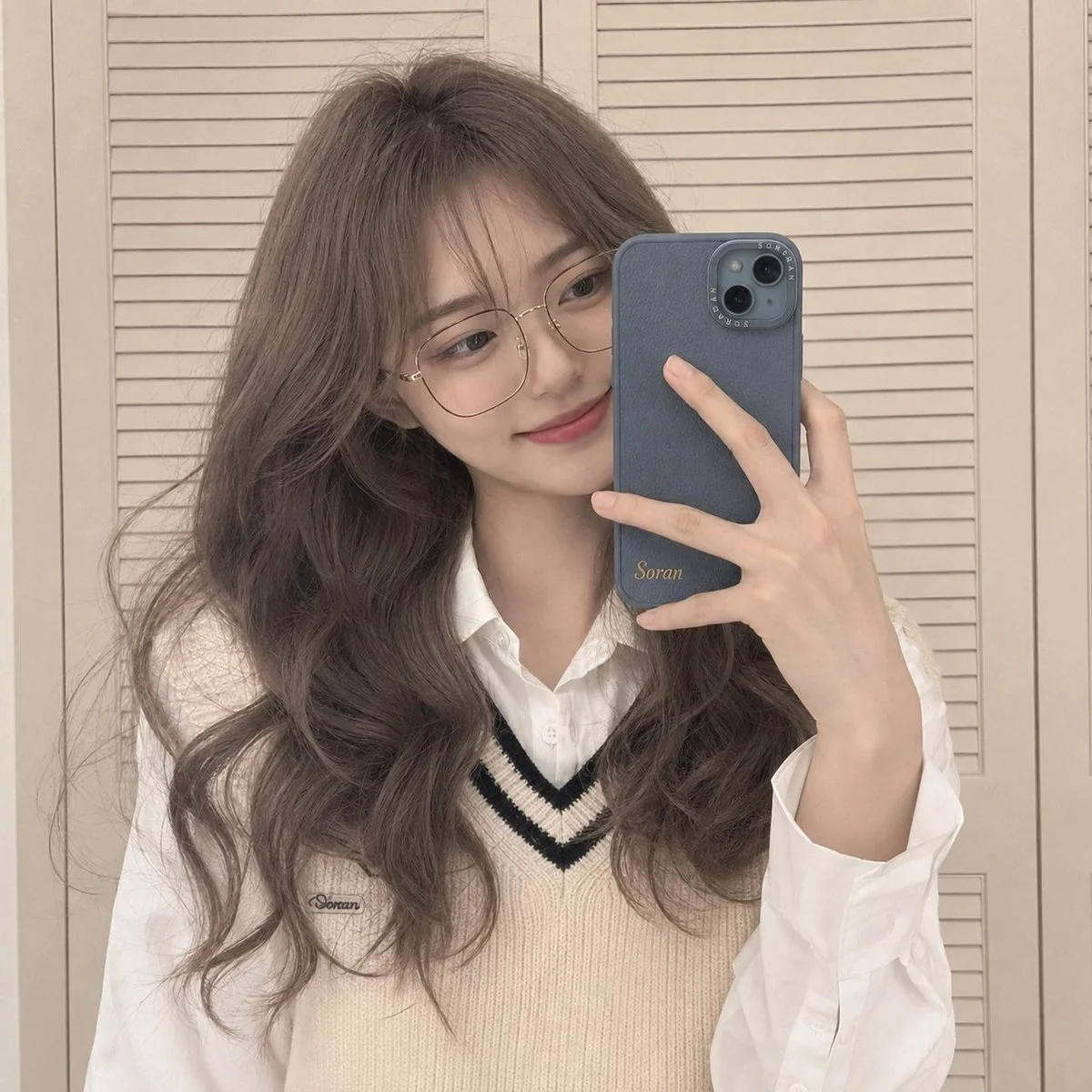 A mirror selfie with a phone partially hiding the face creates a candid mood