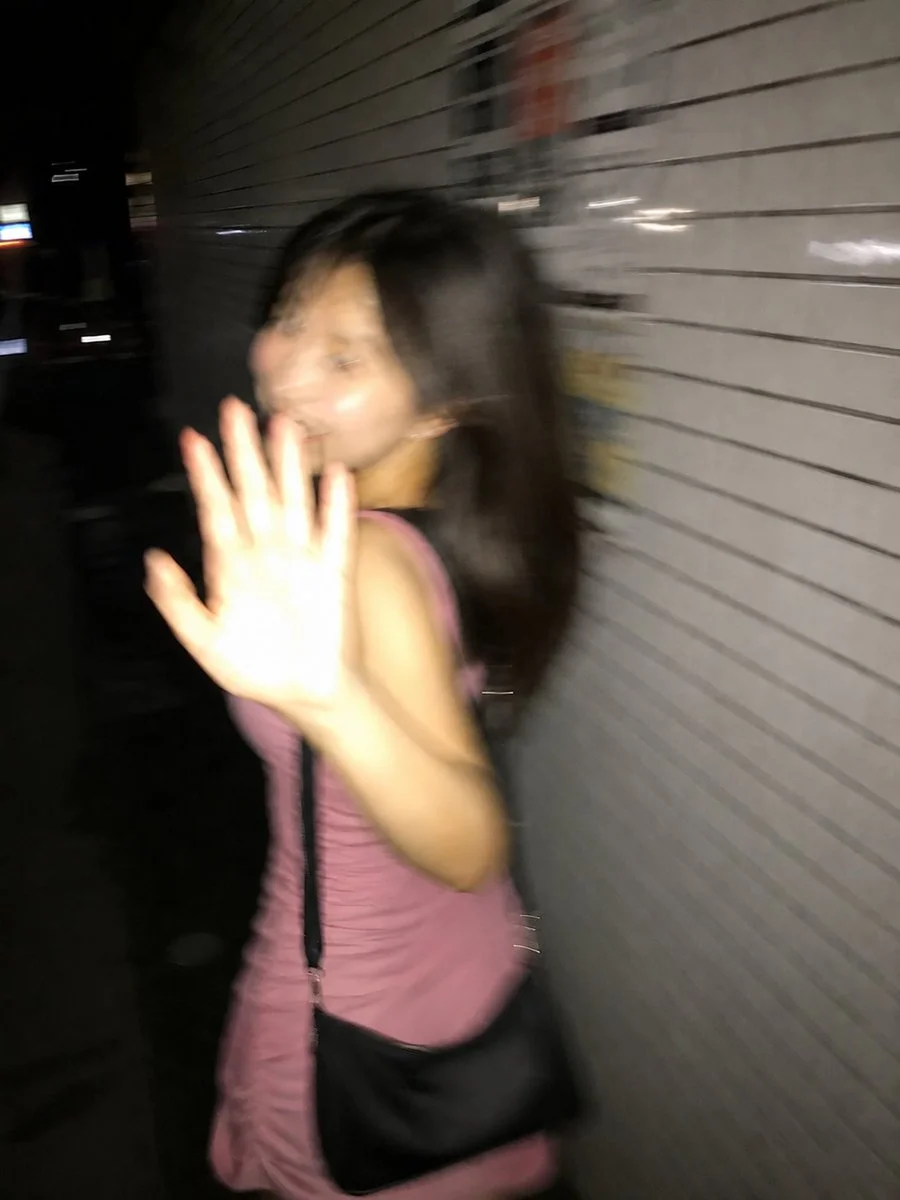 A surprised woman turns back mid-stride on a Tokyo sidewalk