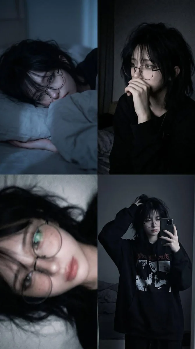 A tired young person lies on a pillow in blue moonlight