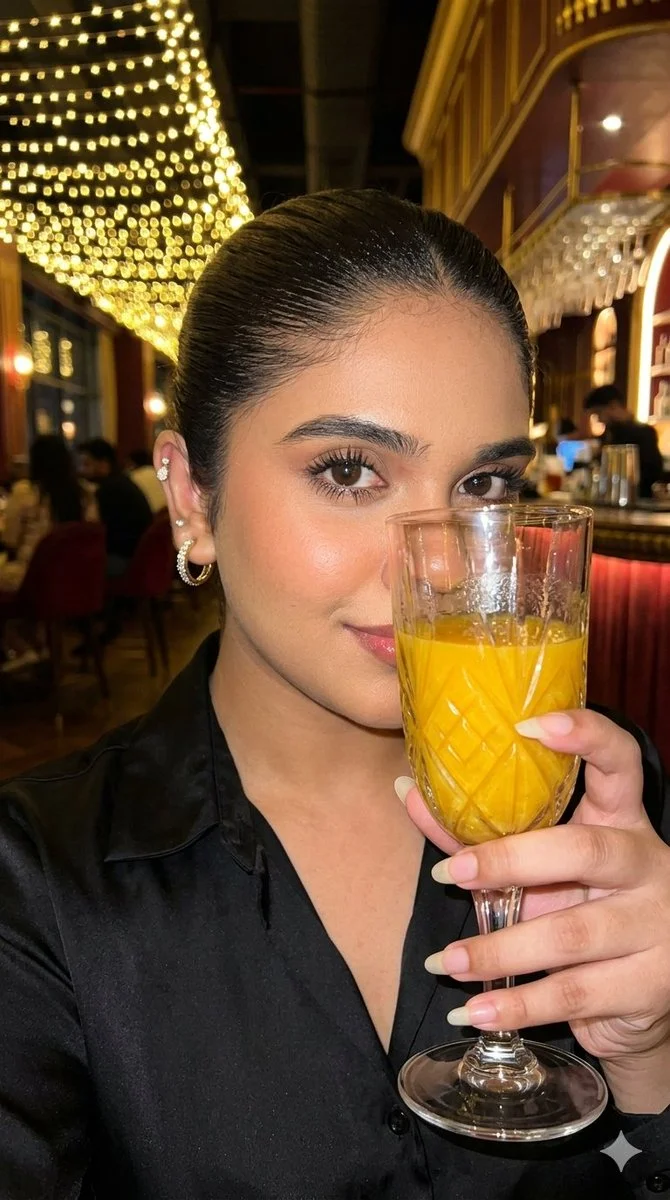 A woman holds red wine glass in a luxurious bar setting
