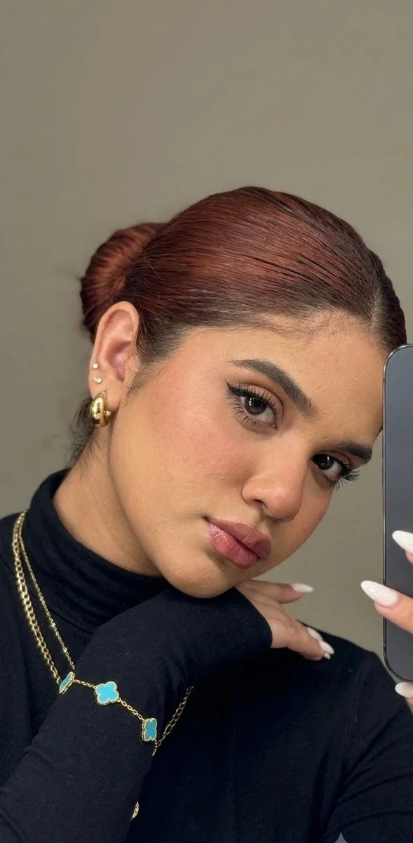 A young girl captures a moody mirror selfie with layered hair