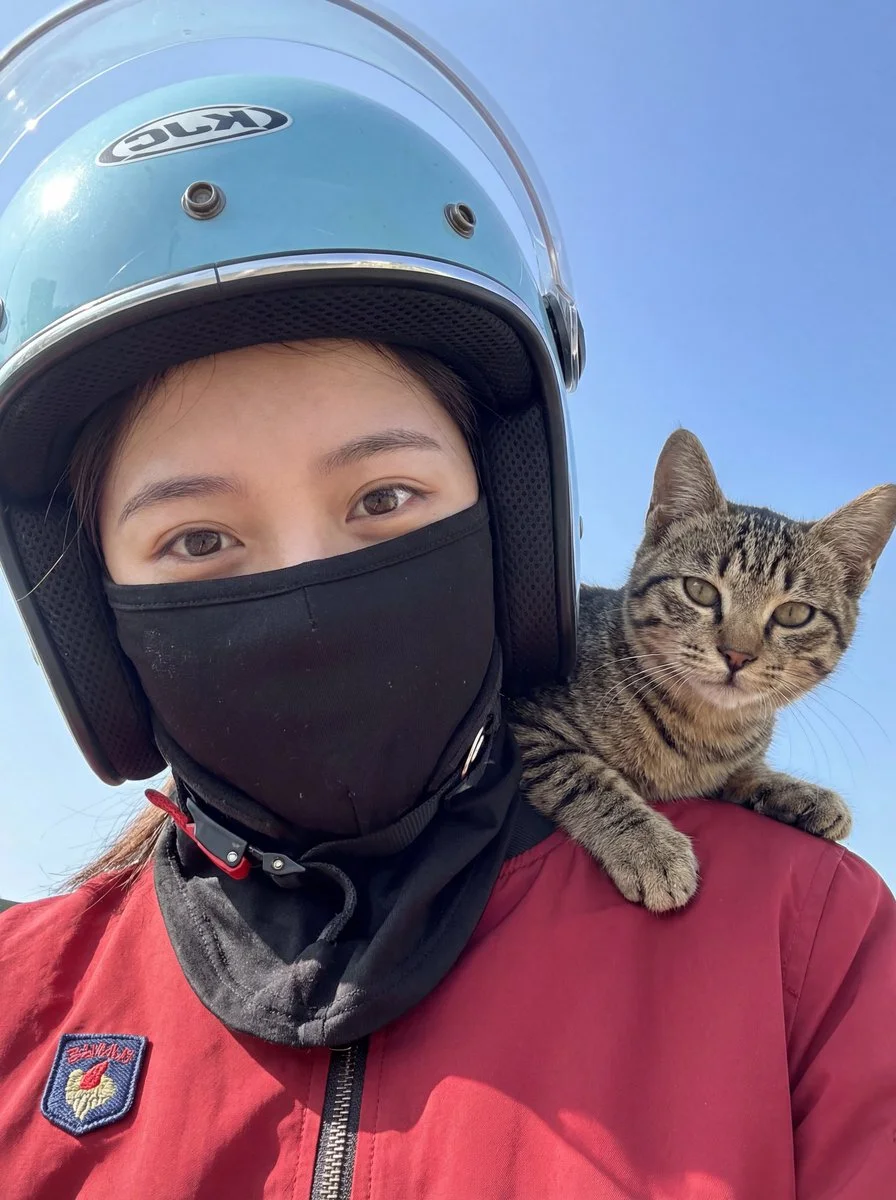 Adventurous Duo: Woman and Cat Under Clear Skies