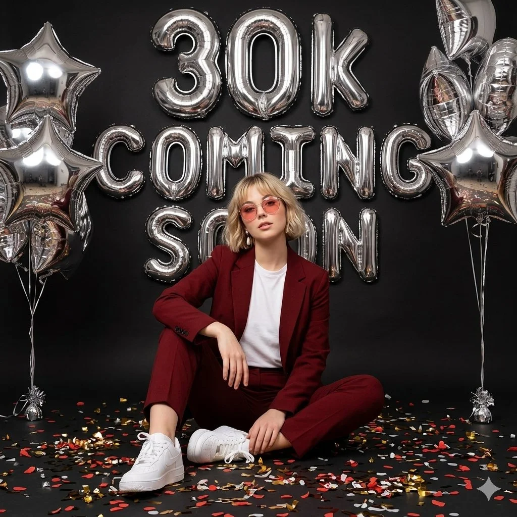 Bold Celebration: Woman in Red Suit Amid Luxe Silver Balloons