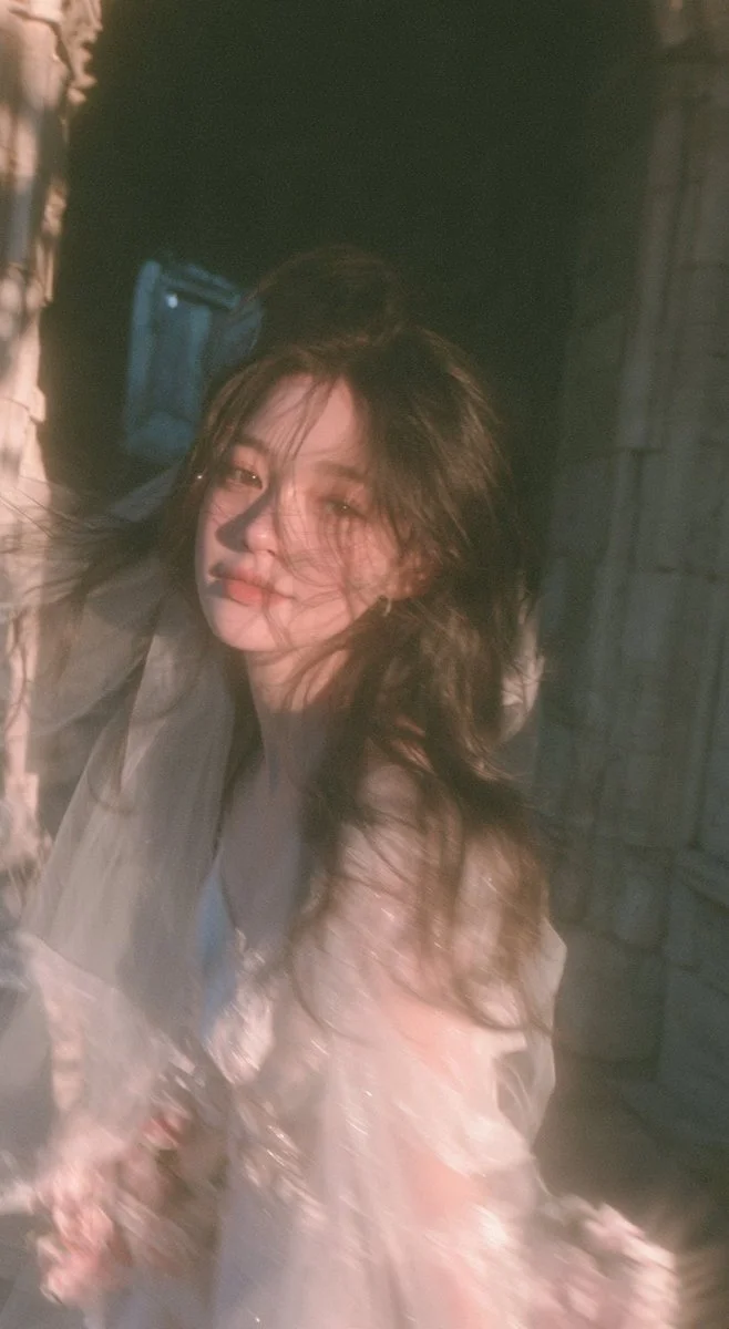 Candid Bride Turns Playfully in Sunlit European Stone Corridor