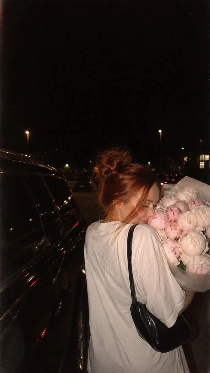 Candid Night Shot of Girl Turning Toward Peony Bouquet