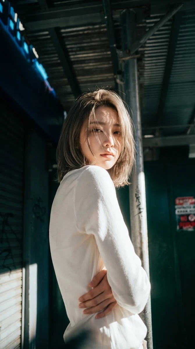 Capturing the Essence of an Elegant Woman in Shadowed Passage