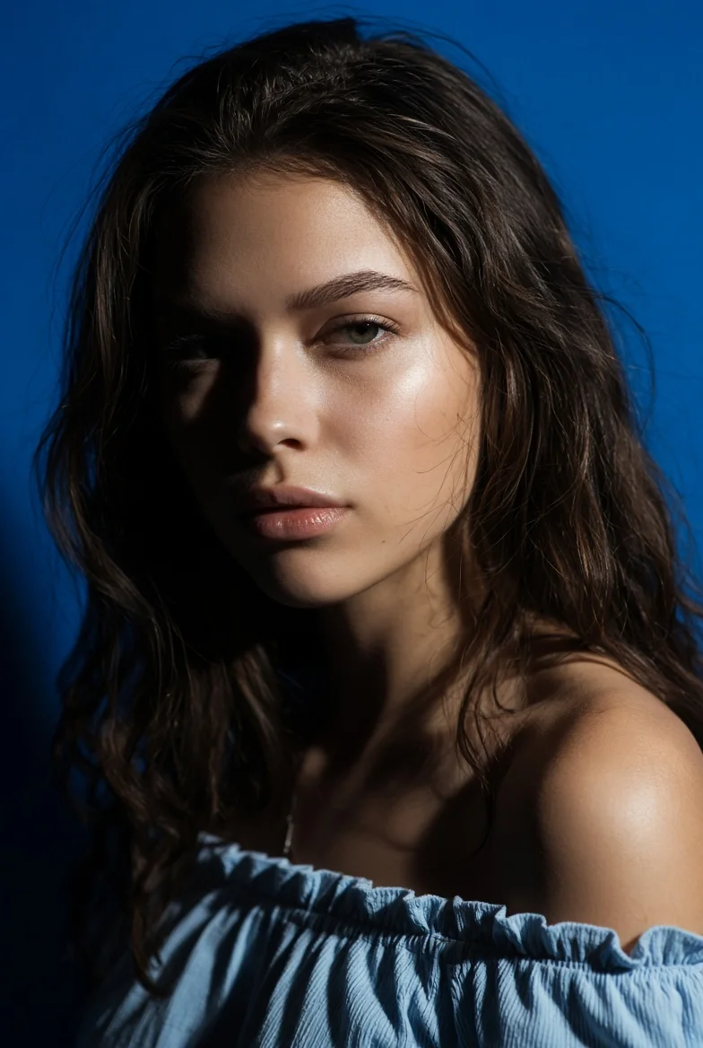 Cinematic portrait captures calm gaze with high-contrast lighting.