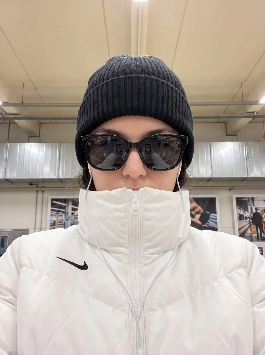 Close-up portrait of woman in black beanie and reflective sunglasses