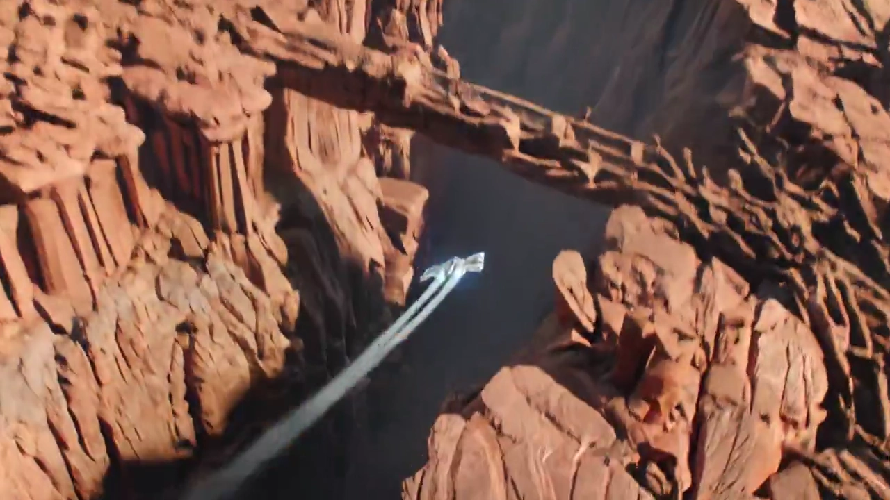 Futuristic Starship Racing Through a Red Alien Canyon