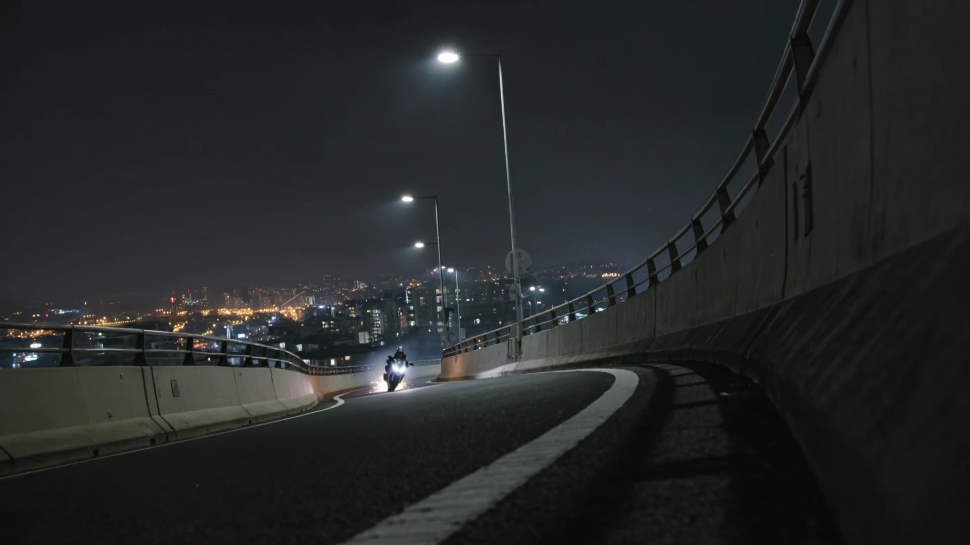 Extreme Motorcycle Lean on Elevated Highway in Urban Night