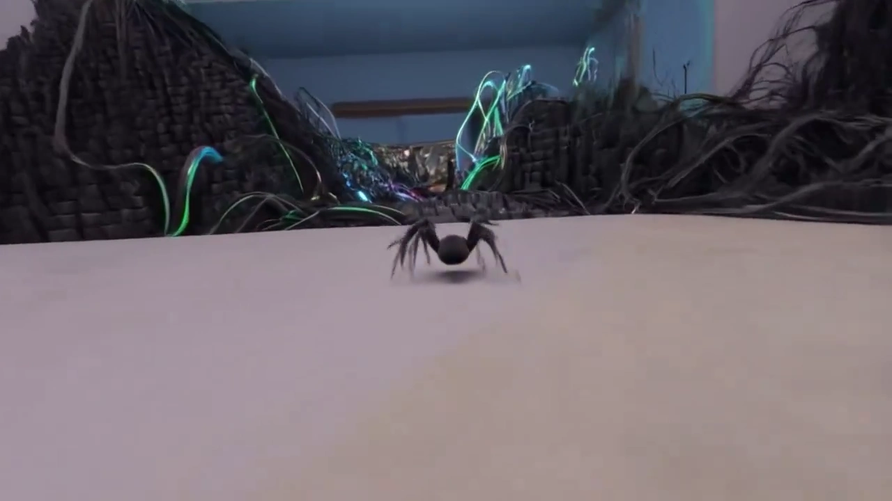 Microscopic Spider Navigates a Vibrant Gaming Setup at Lightning Speed