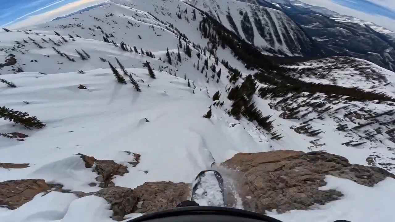 Chasing the Edge: Snowboarder Conquers Steep Alpine Heights