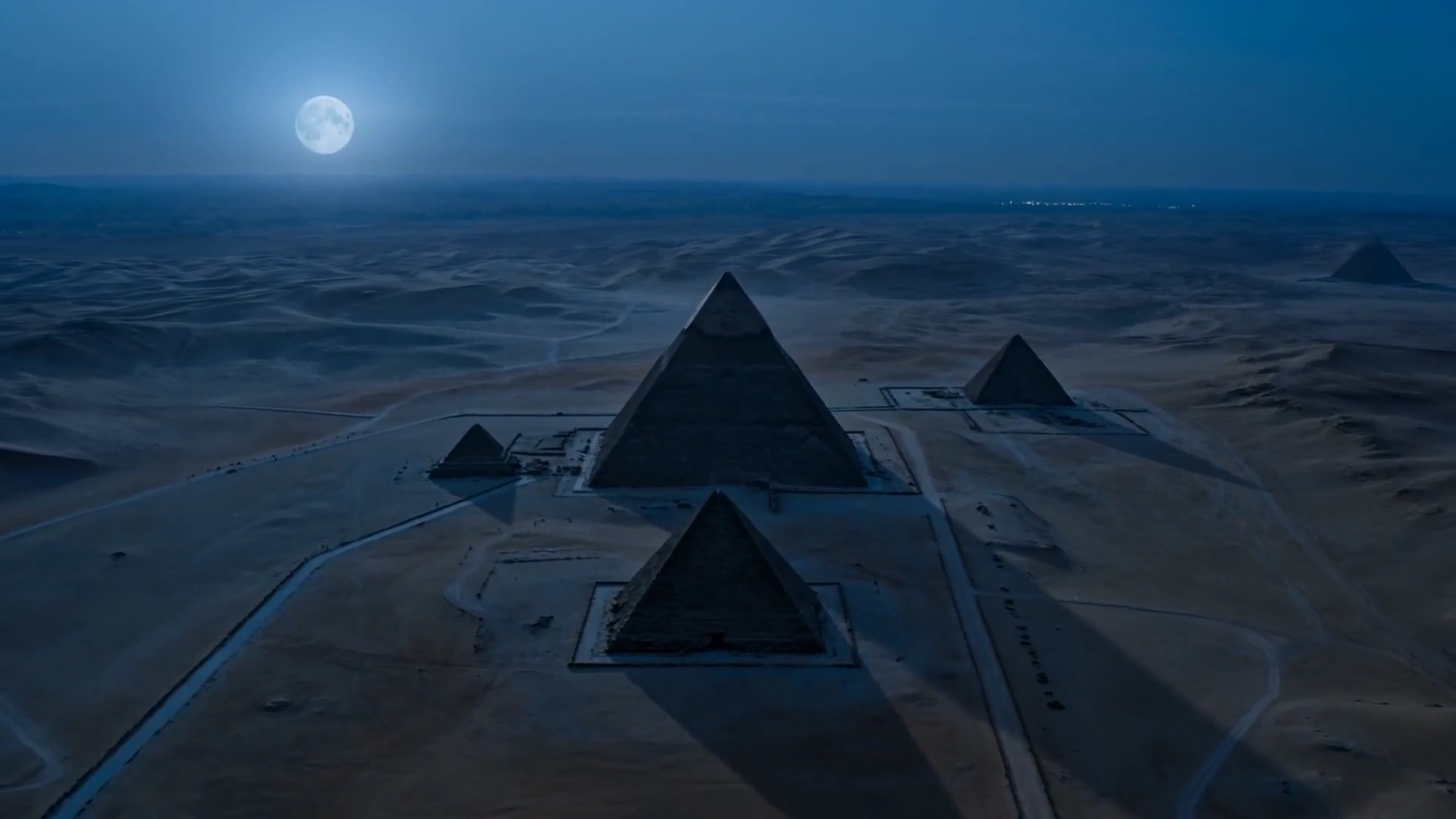 Golden Hieroglyphs Illuminate Pyramids in a Nighttime Descent