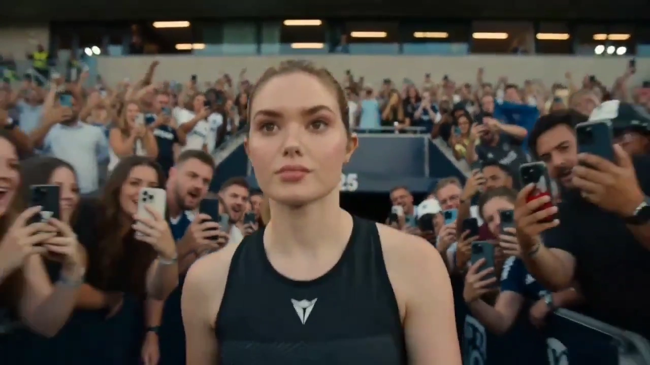 Confident Female Star Juggles Ball as LED Screens Blaze at Match