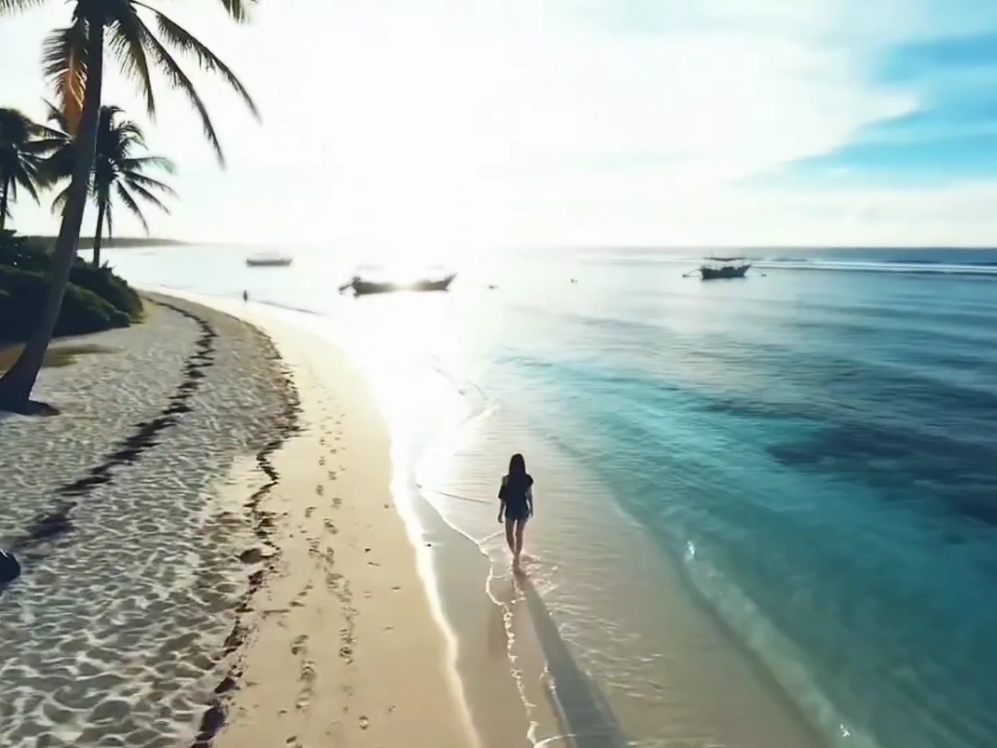 Tropical Sunrise Unveils a Solo Wanderer on Golden Sand