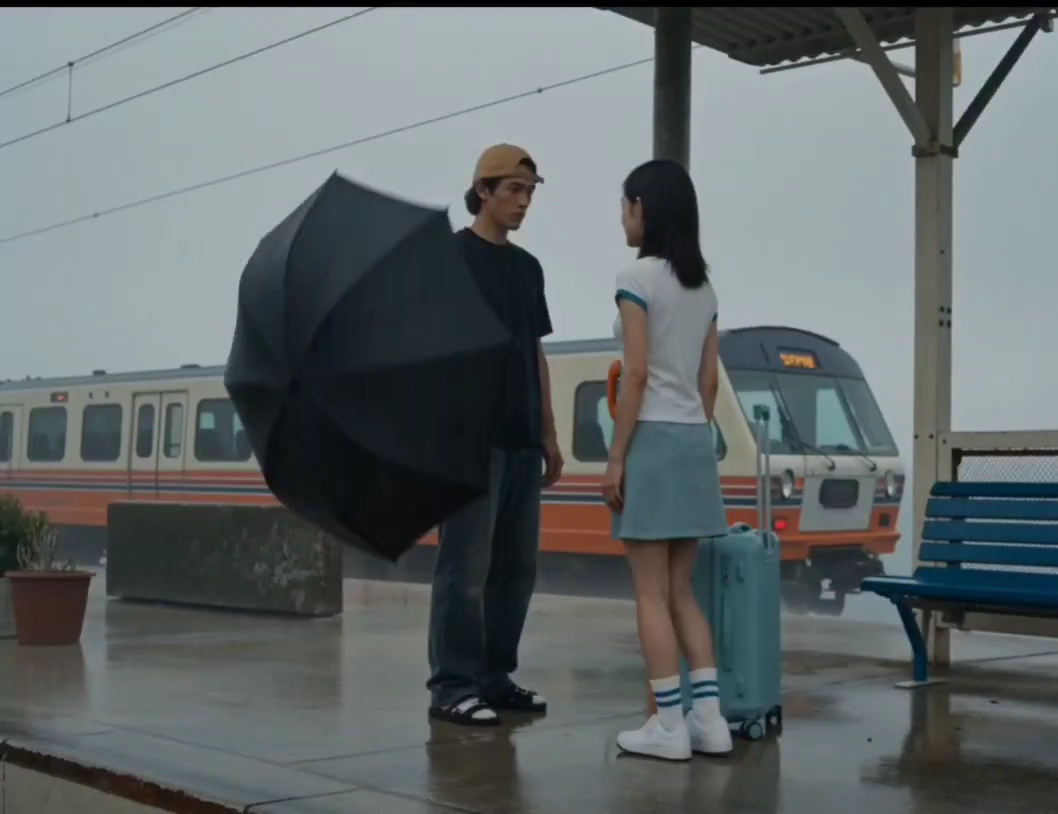Lovers Part in Heavy Rain at a Retro Coastal Train Stop