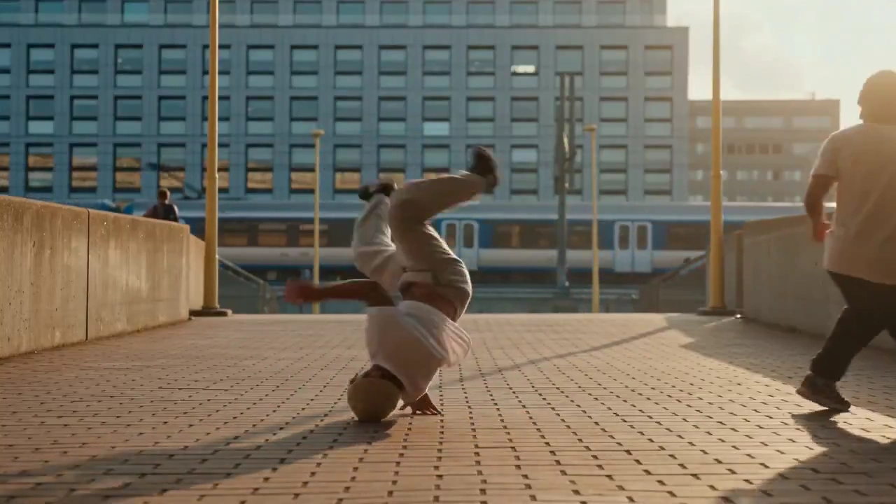 Late Sun Casts Long Shadows as Breakdancers Converge
