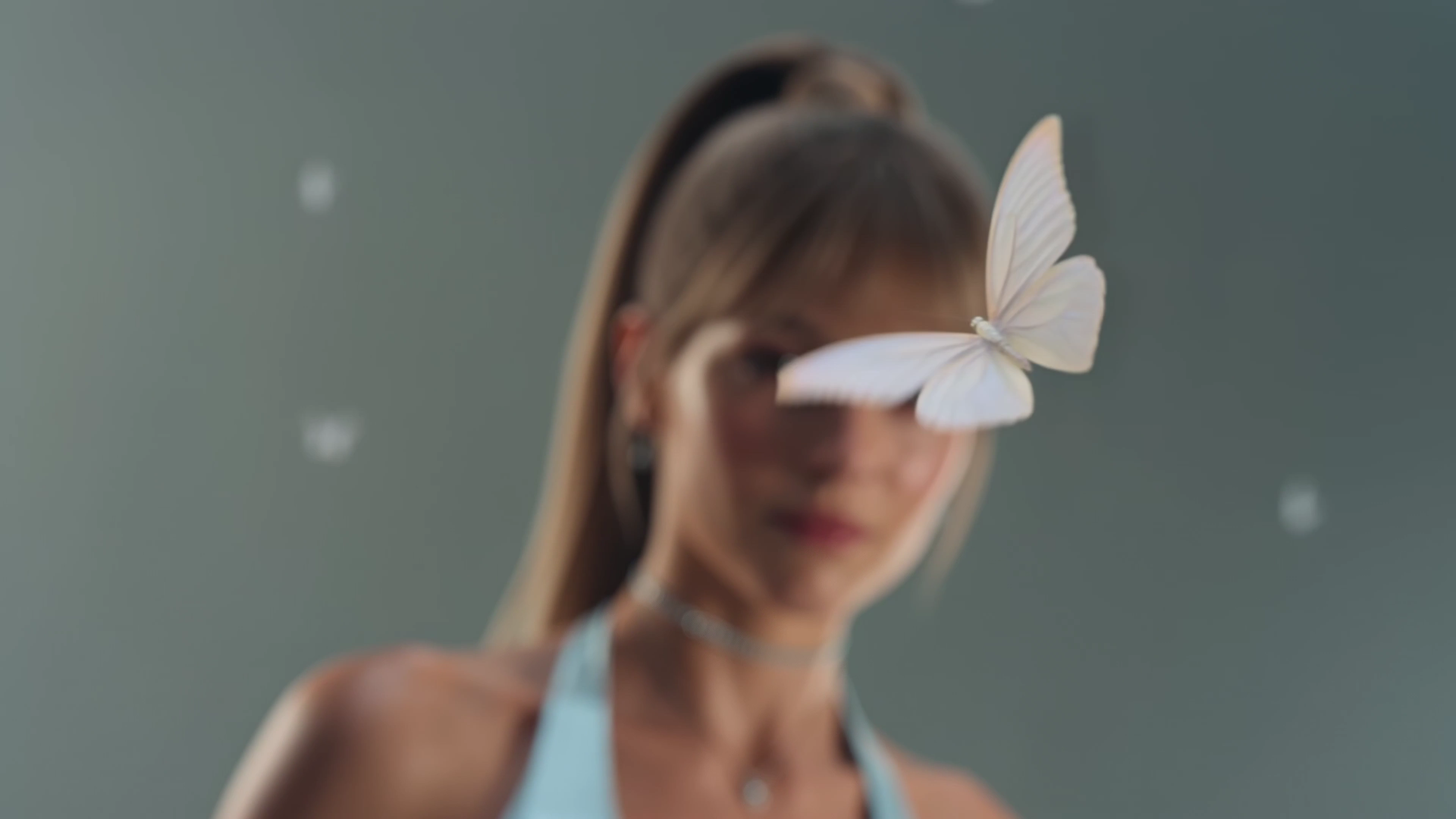 Silver Jewelry Gleams as a Butterfly Alights on Rose Lips