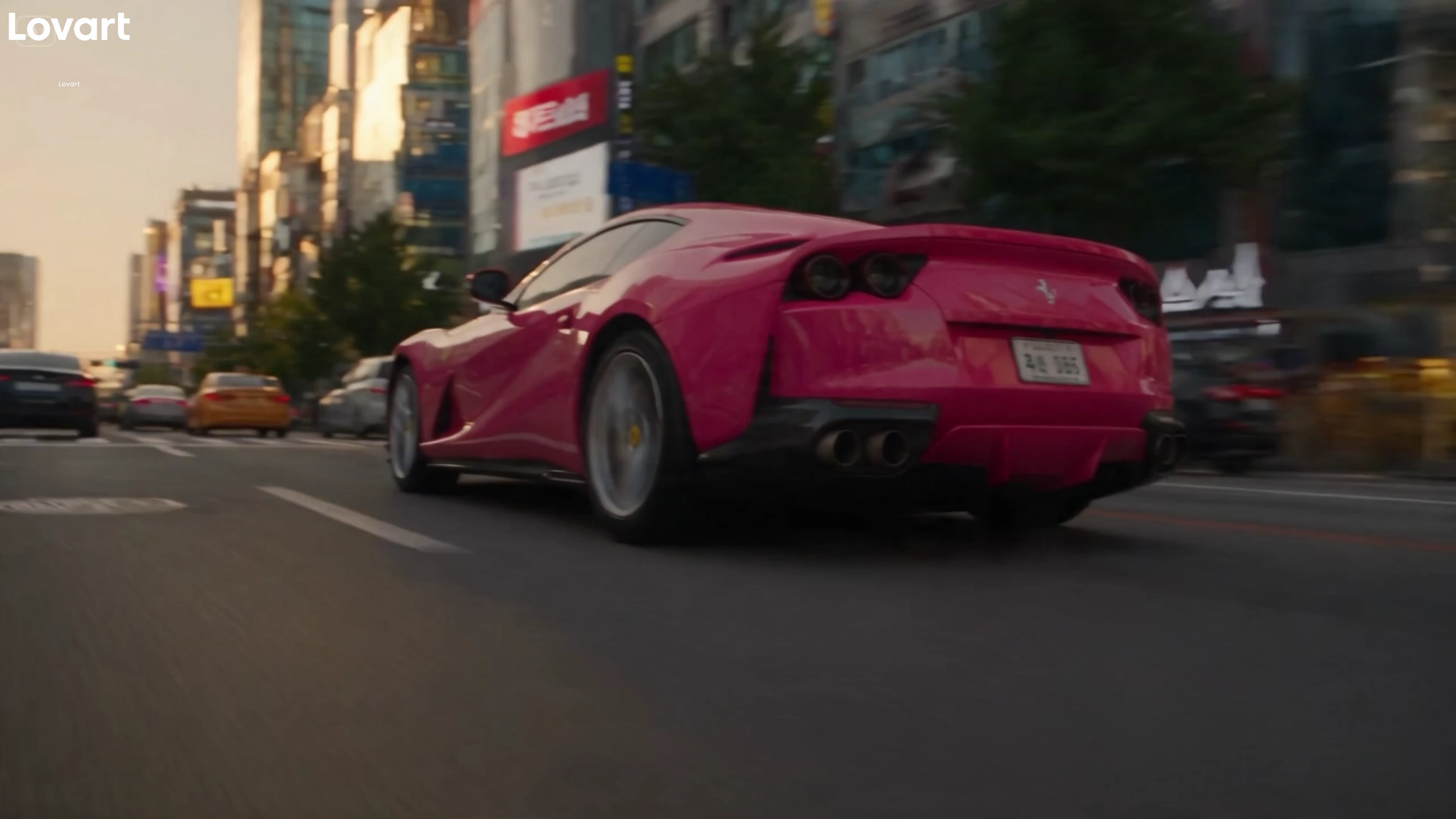 Spider-Woman Leaps Across Rooftops While a Pink Ferrari Speeds Below