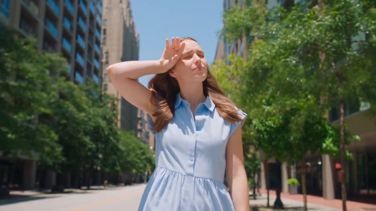 Frosty Soda Mist Cools a Woman Beneath the Summer Sky