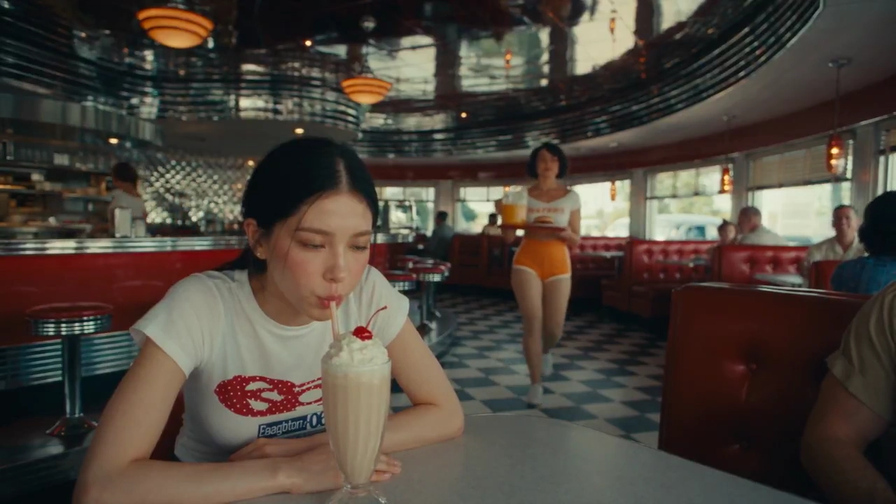 Bullet-Time Diner Chaos: Frozen Juice Orbiting a Stoic Milkshake Drinker