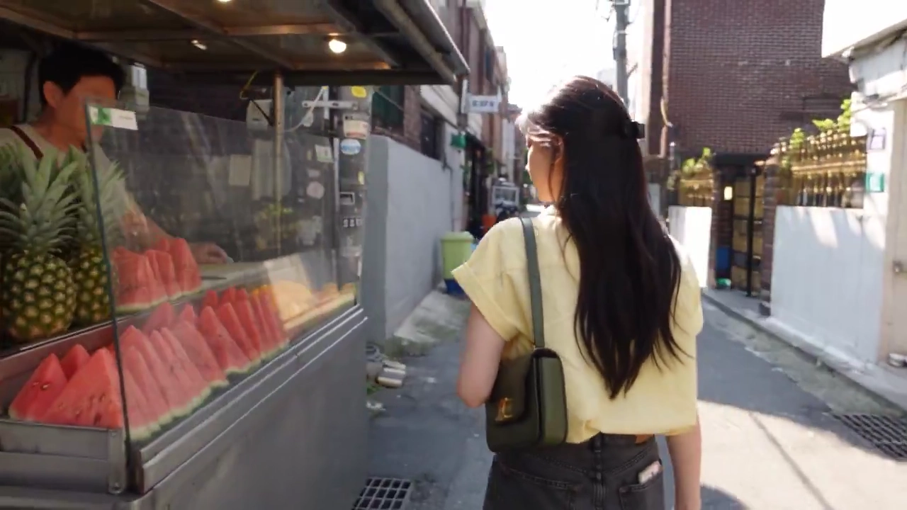 Butter-Yellow Blouse Woman Tastes Pineapple in Sunny Seoul Alley