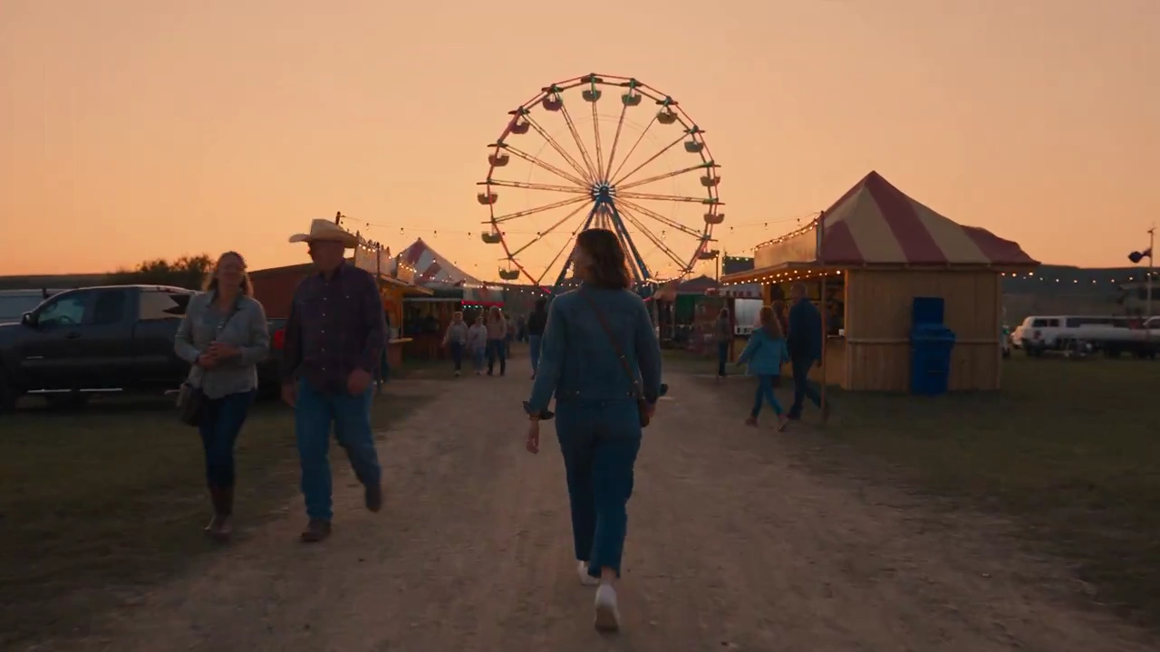 Ferris Wheel Lights Spin While Fireworks Bloom Over The Farmland