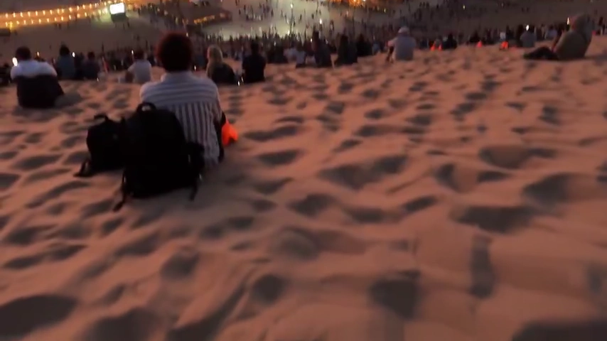 Golden Pathway Leads Through Dunes Toward Oasis Pavilion at Dusk