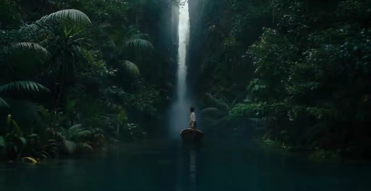 Solitary Explorer Glides Through Emerald Canyon Toward Secret Cascades