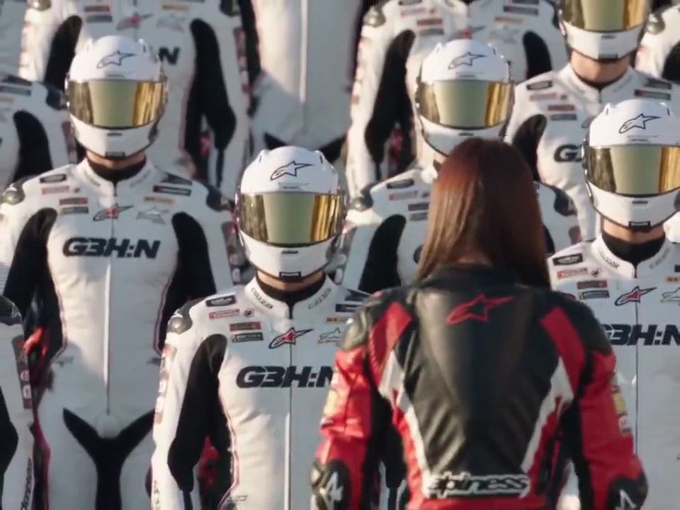 Pit Crew Swirls Around Stoic Racer in Cinematic Daylight