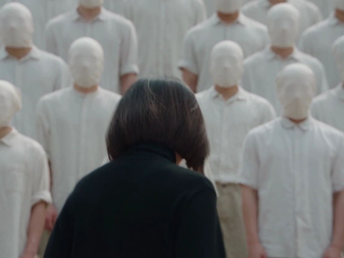 Dark Fashion Film Shows Silent Woman Facing Chaos of Moving Crowd