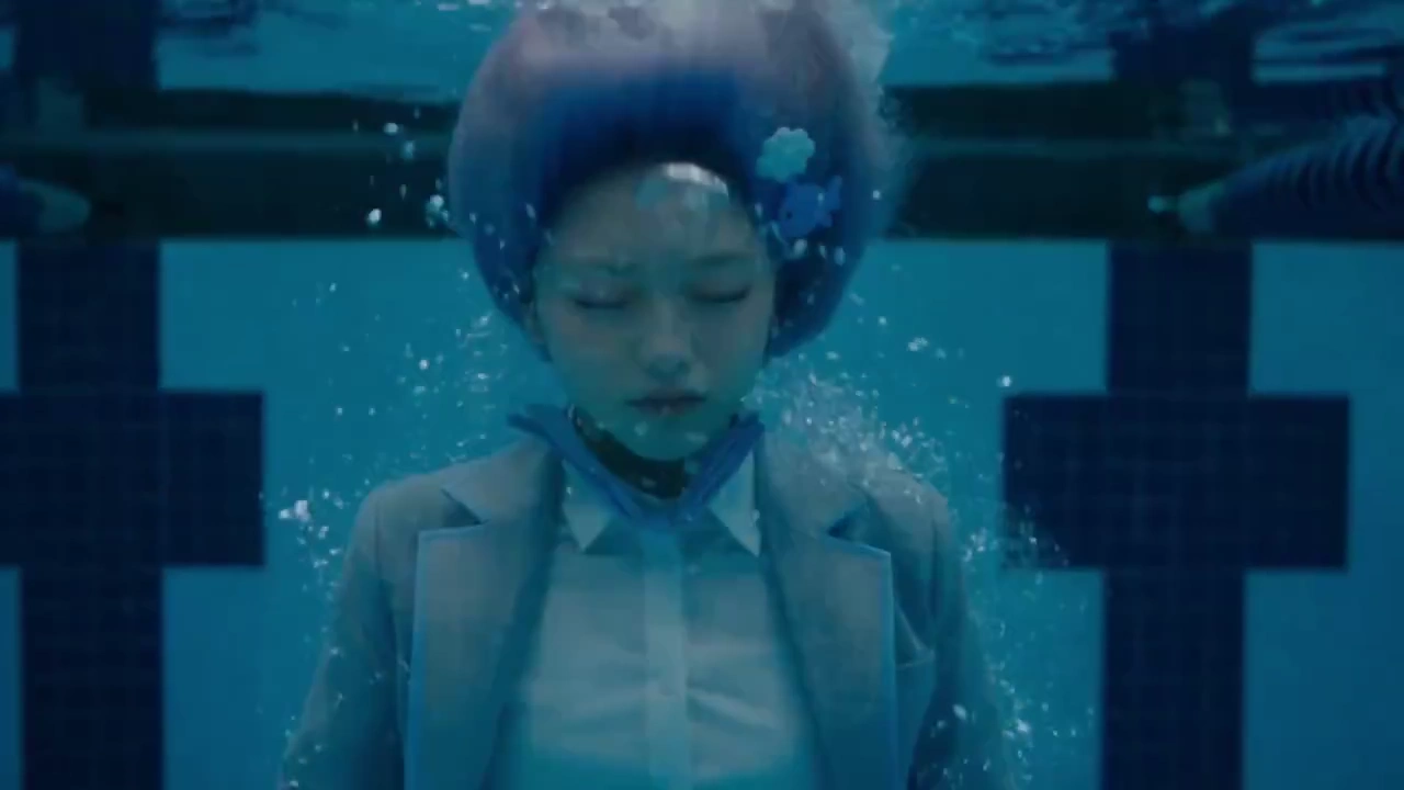 Schoolgirl in Gray Blazer Runs Wild Through a Blue-Tiled Swimming Pool
