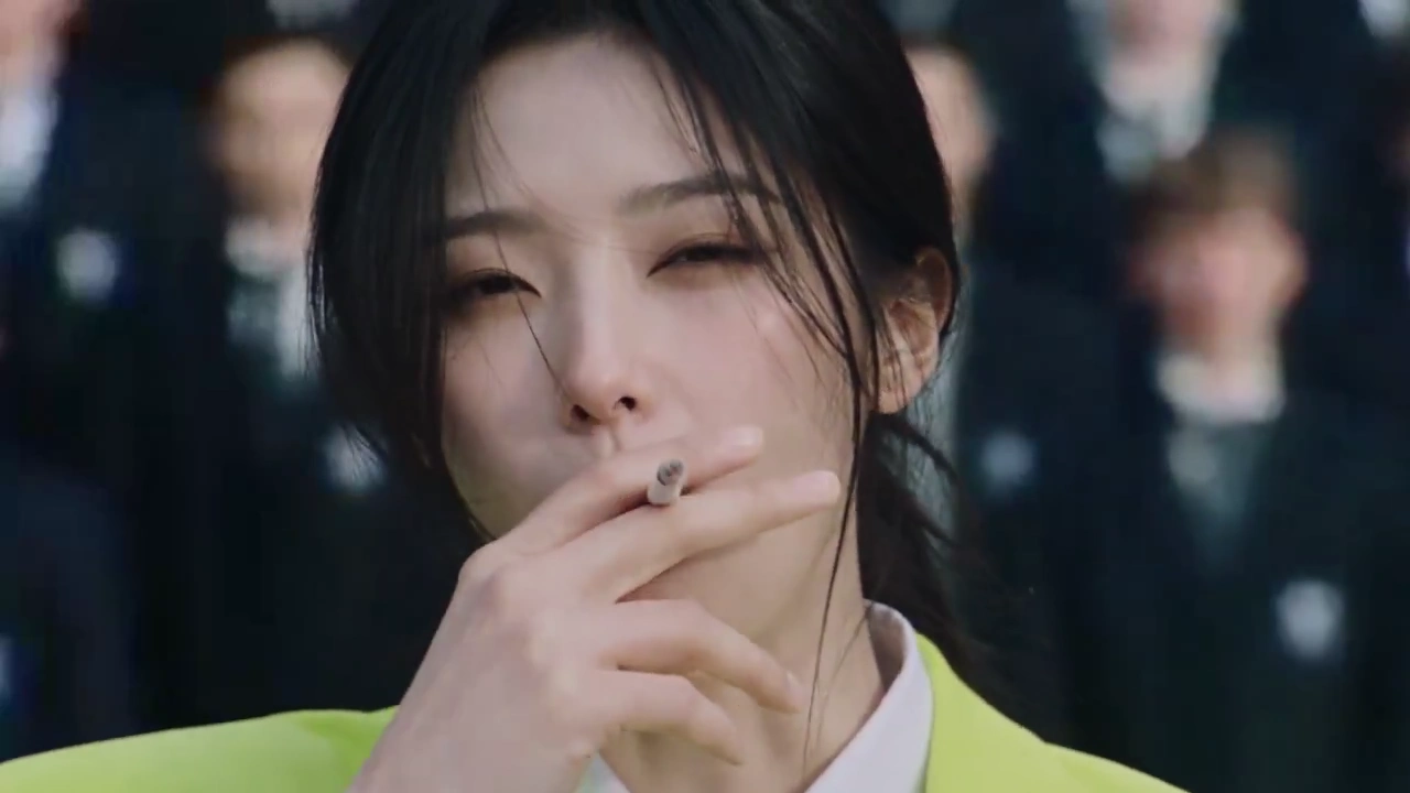 Smoking Woman in Acid Lime Suit Stands Still as Crowd Rages