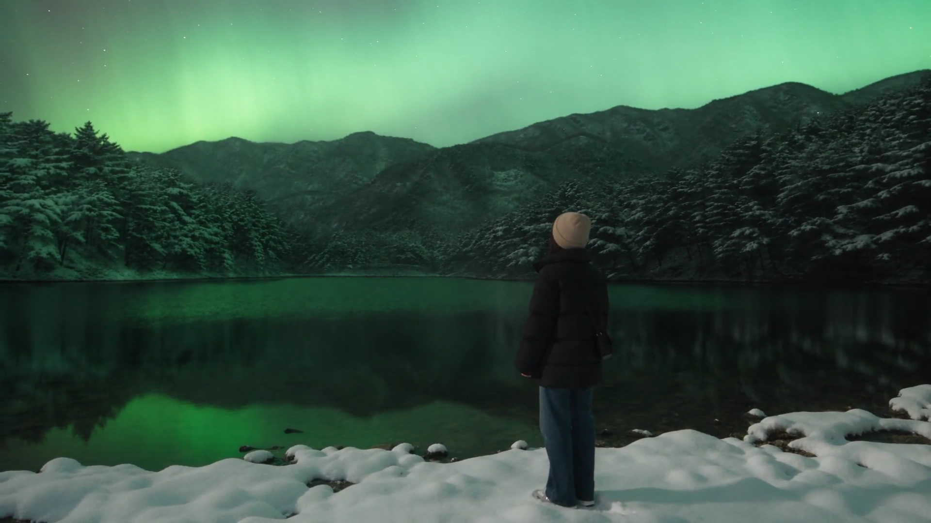 Emerald Aurora Shimmers as Woman Breathes in Winter Night