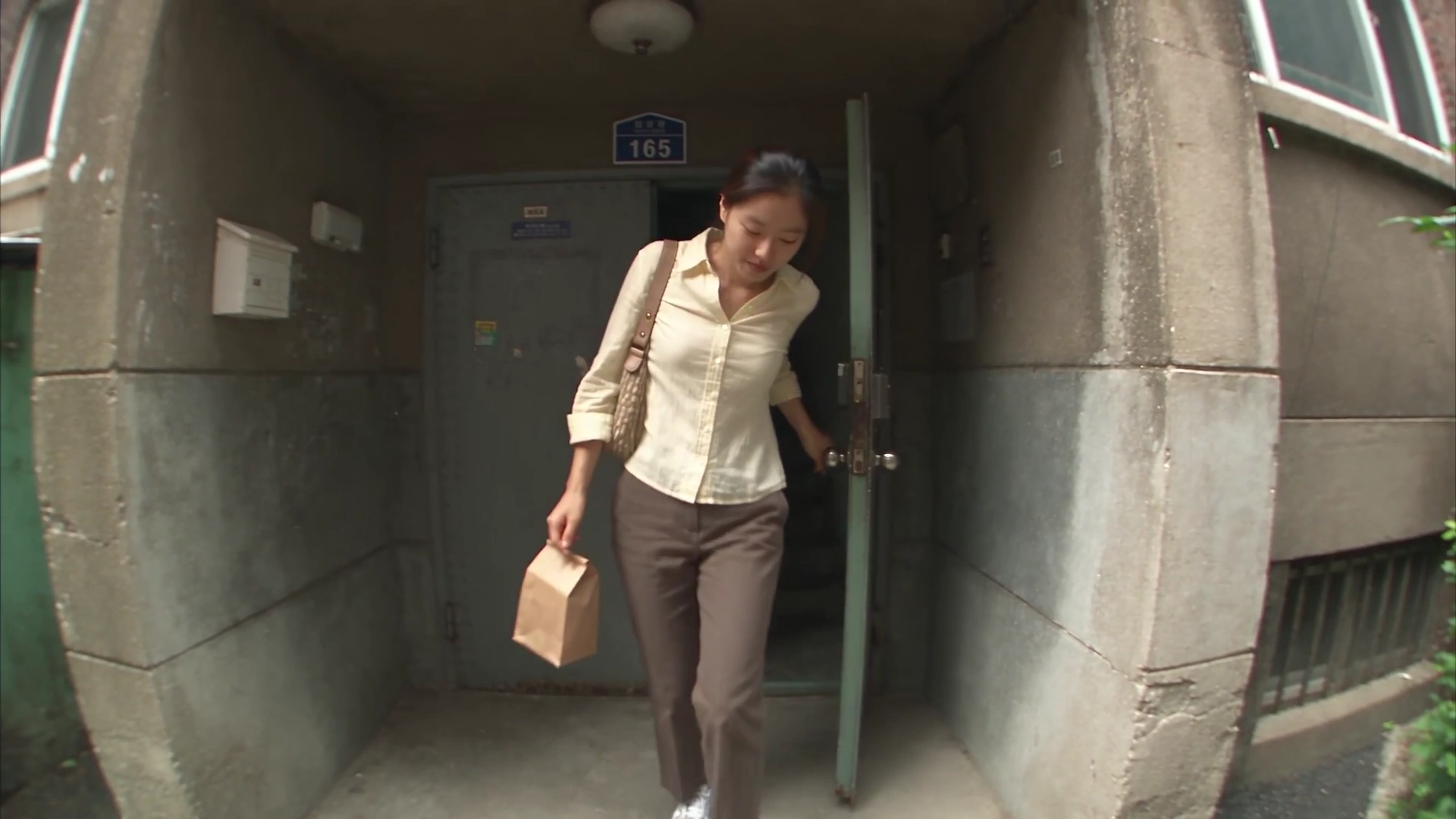 She Smiles at the Camera Then Disappears Around a Pyongyang Corner