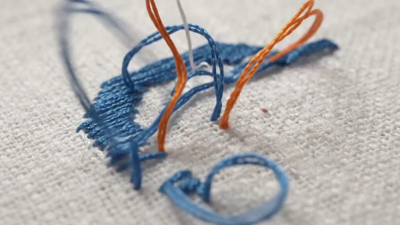 Embroidery Threads Rise and Stitch a Logo on Cotton