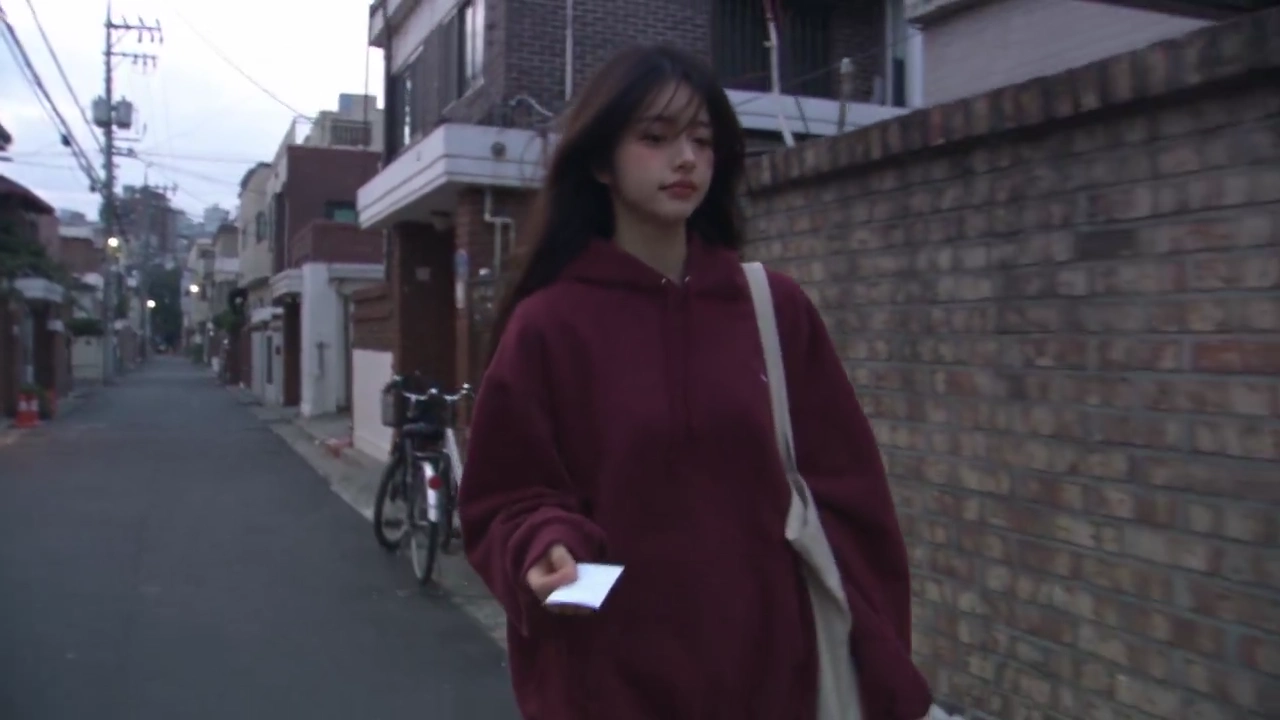 Wind Tugs a Small Receipt Away From a Strolling Woman