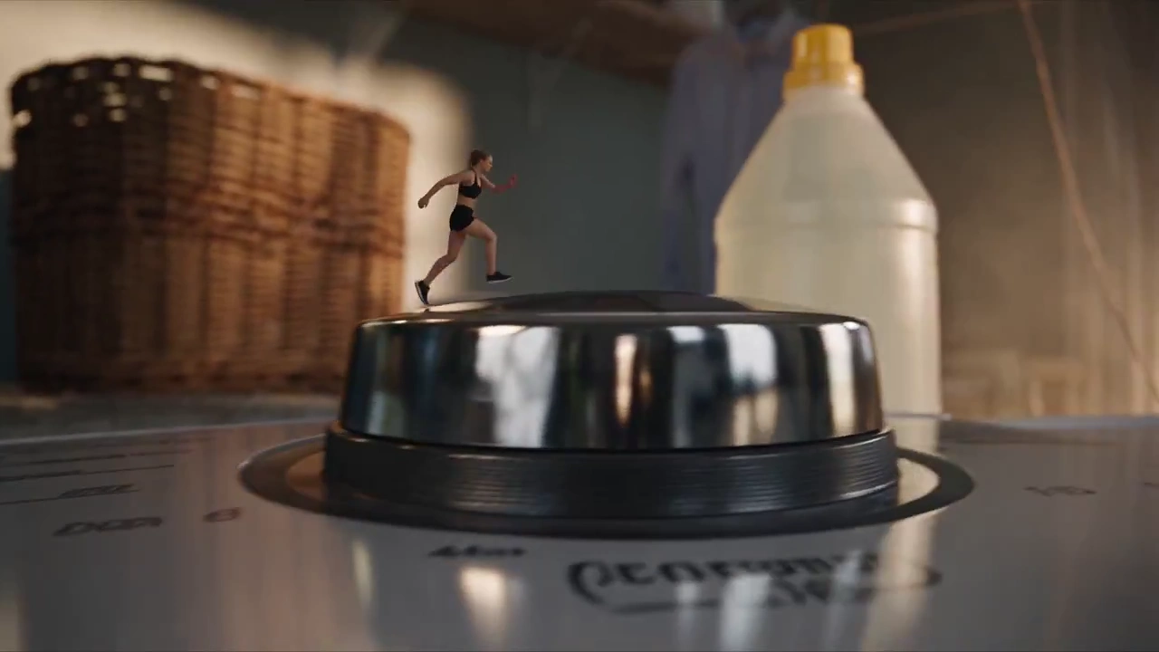 Miniature Woman Rides Towel Parachute Through Turbulent Laundry Room
