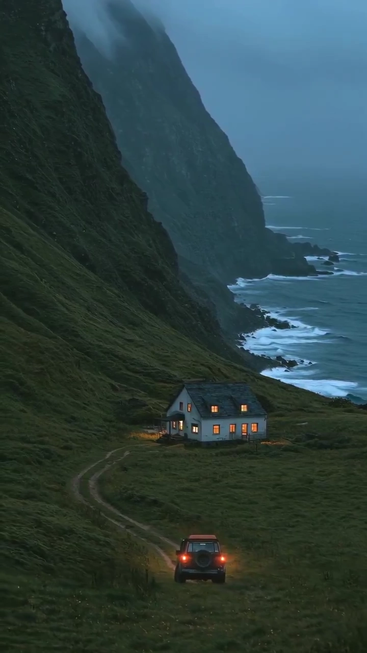 Moody Drone Reveals Tiny Vehicle Crossing Rugged Valley to Warm Haven