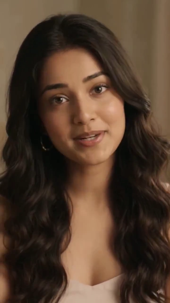 Wavy Haired Woman Speaks Softly in Warm Cinematic Portrait