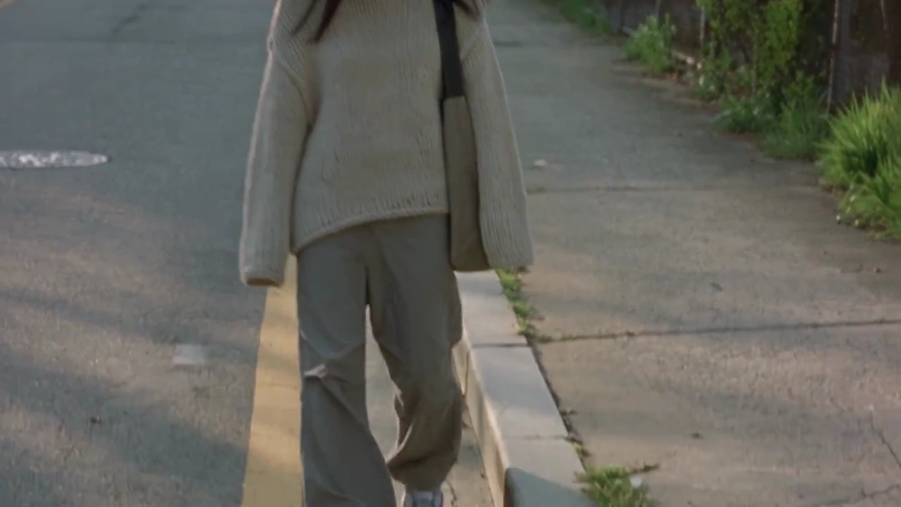 Handheld 2000s Video Follows Korean Woman Who Spots Wildflower Between Concrete