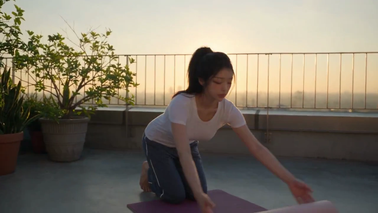 Sunrise Yoga Flow: Woman Stretches in Golden Light on Terrace