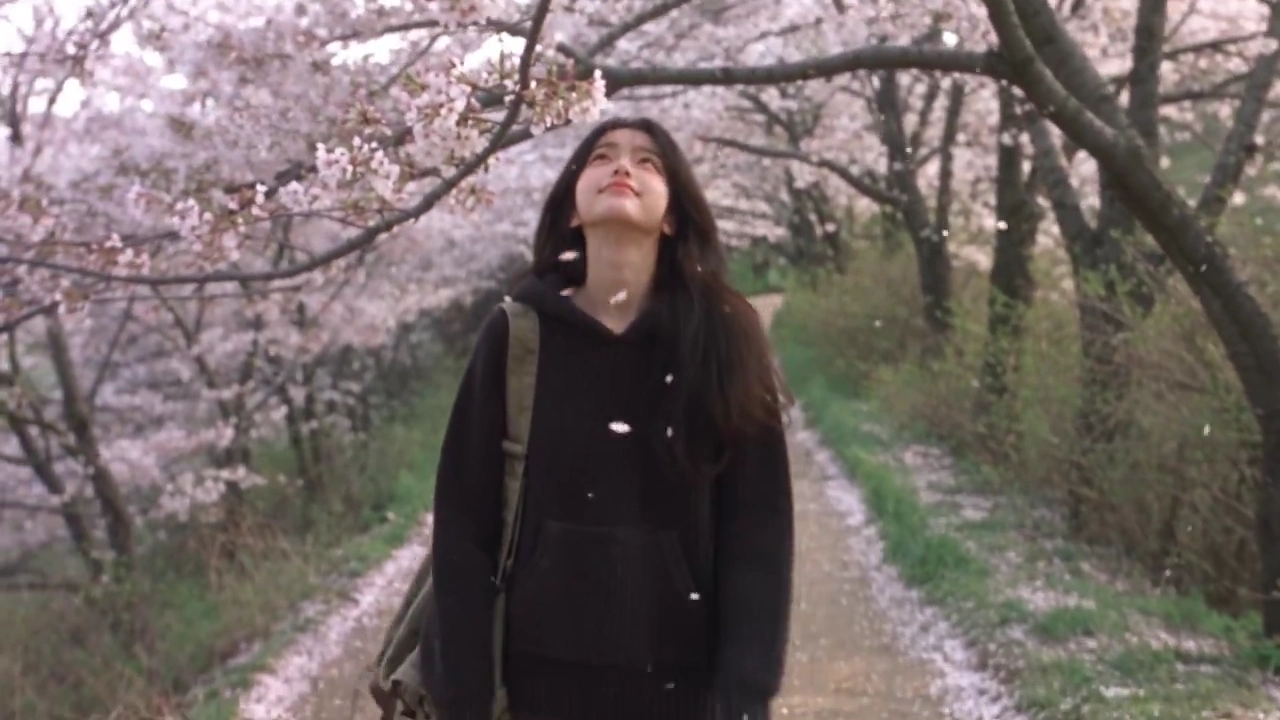 Playful Puzzlement Unfolds As She Finds Tiny Petal In Her Hair