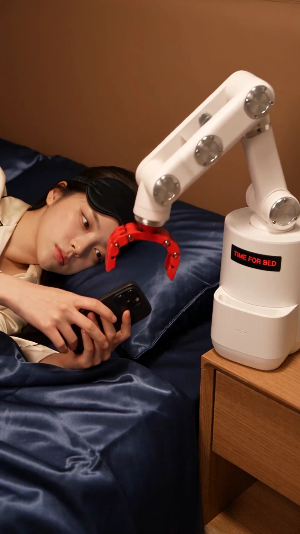 Spring Fist Knocks Out Phone Addict as Machine Tucks Him In
