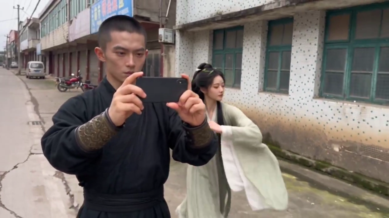 Male Warrior Films Selfie While Dancing Woman Hits Pole Behind