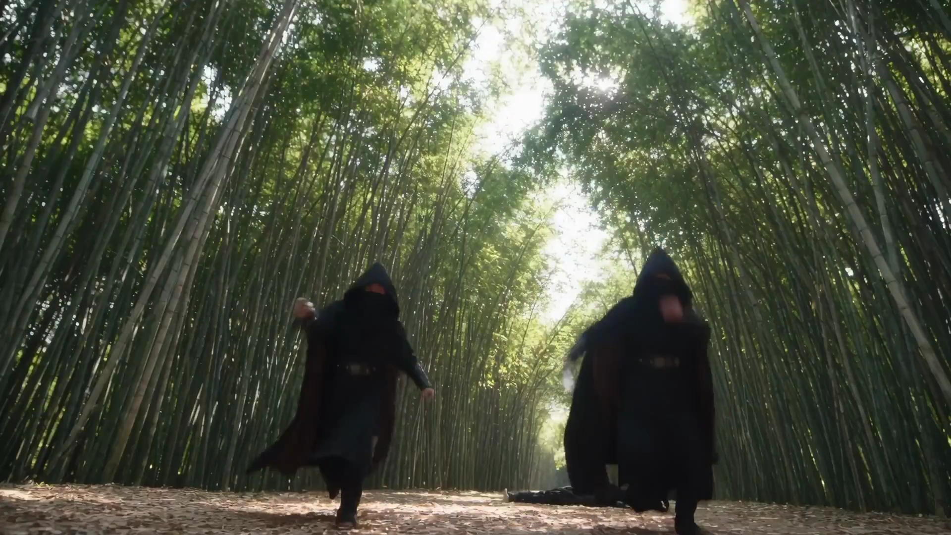 Blade Master Deflects Multiple Attackers Amidst Swaying Bamboo Stalks