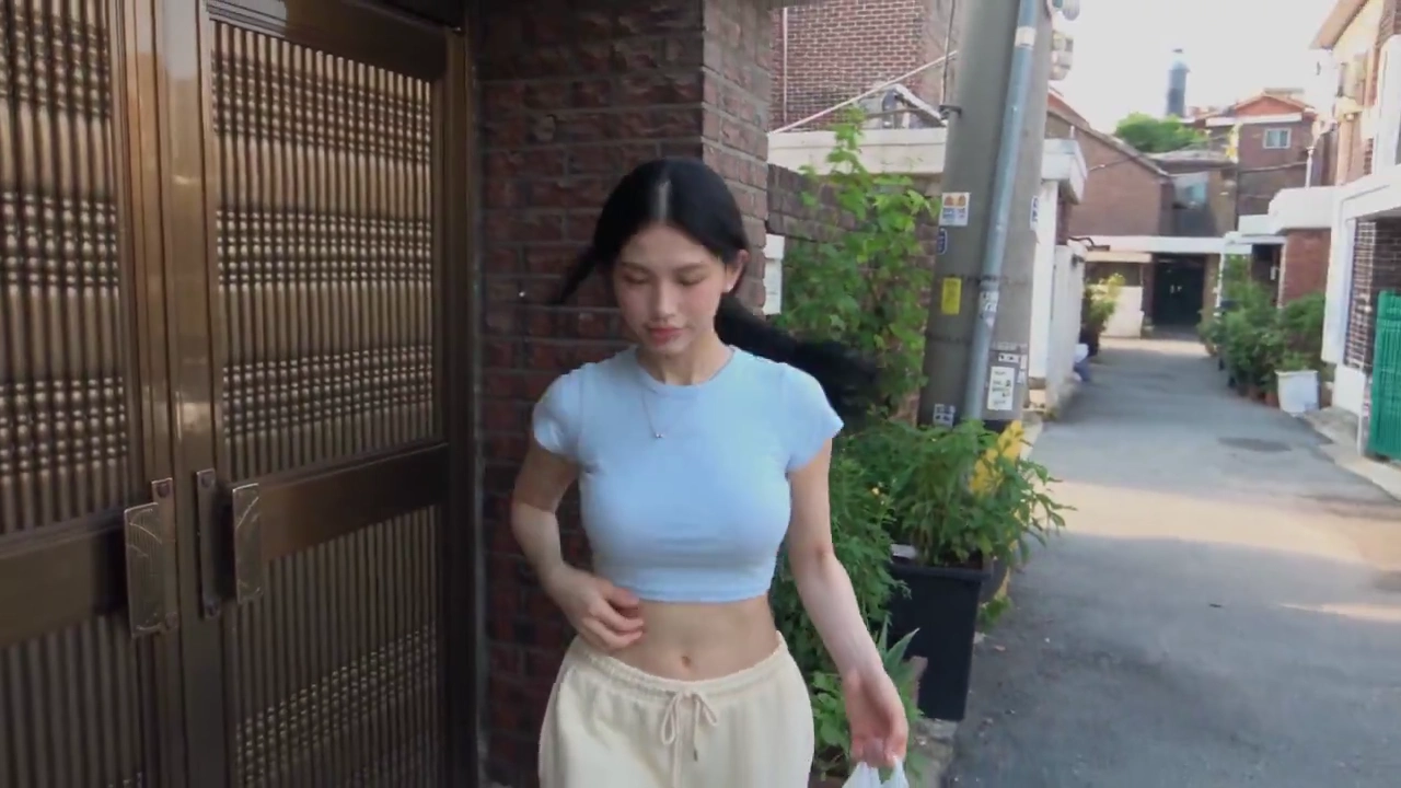 Playful Seoul Woman Enjoys Lollipop While Wandering an Old Neighborhood